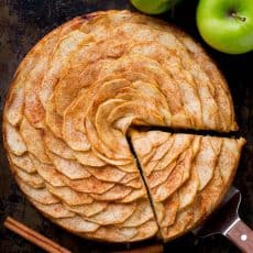 This Apple Tart is a looker! It's crowned with a beautiful rose pattern of sliced apples (and it's easier than you think!). The juices from the cinnamon-sugar coated apple slices, bake into the buttery soft crust. This apple rose tart is lightly sweet and completely irresistible. | natashaskitchen.com