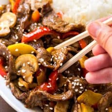 MUST TRY quick beef stir-fry recipe loaded with mushrooms, bell peppers and zucchini. Serve beef stir-fry over steamy white rice. The easy sauce will surprise you! | natashaskitchen.com