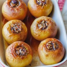 Baked apples filled with cinnamon sugar in a rectangular baking dish.