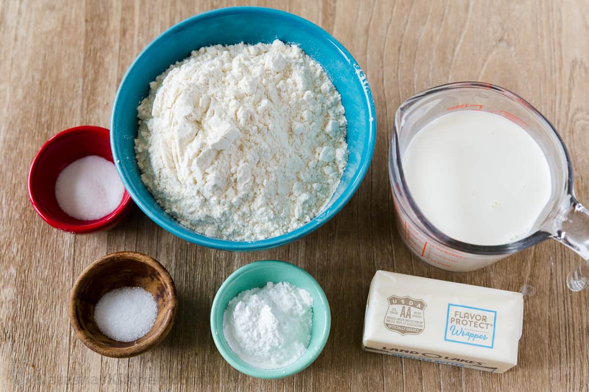 Ingredients to make biscuits with butter, flour, half and half, baking powder, salt and sugar