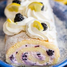Fluffy and moist Blackberry Lemon Cake Roll (Swiss Roll) that's easier than you think! Impress everyone with this show-stopping Blackberry Lemon Cake Roll | natashaskitchen.com
