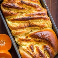 This Braided Easter Bread has the softest crumb. It is laced with farmer cheese and studded with apricots and orange zest which gives the entire loaf amazing flavor and aroma. Make this Easter Bread your new Easter tradition. This brings a cheese Paska and Classic Kulich together into 1 impressive Easter bread! | natashaskitchen.com