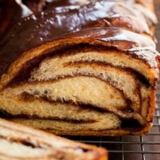 Close up of chocolate babka with a slice cut from the end.