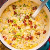 Corn chowder in soup pot with ladle