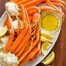 Crab legs served on platter with butter dipping sauce