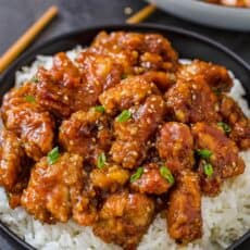 General tsos chicken served over a bowl of white rice