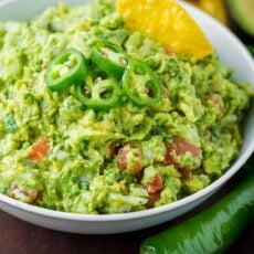 Spicy guacamole garnished with jalapeno peppers