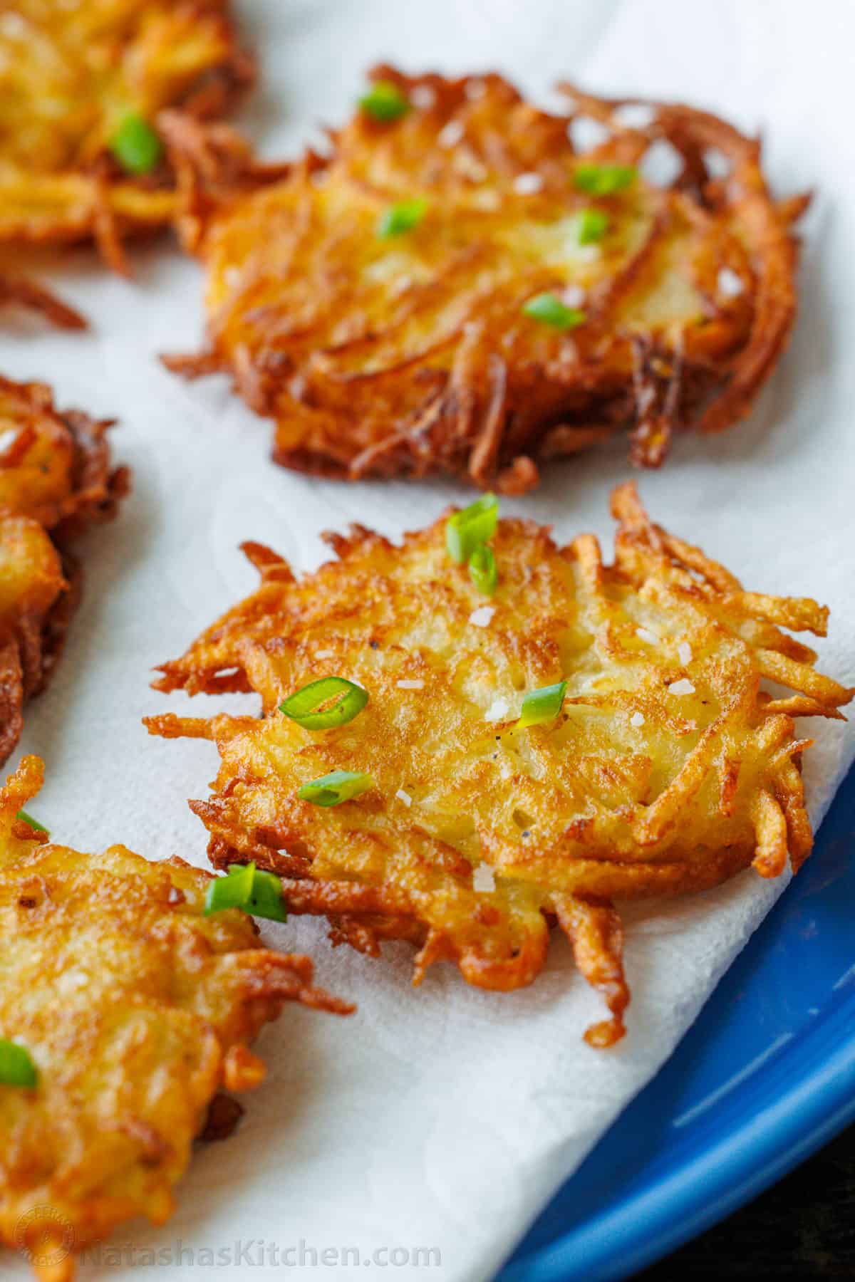 Latkes sprinkled with fresh chives on a plate