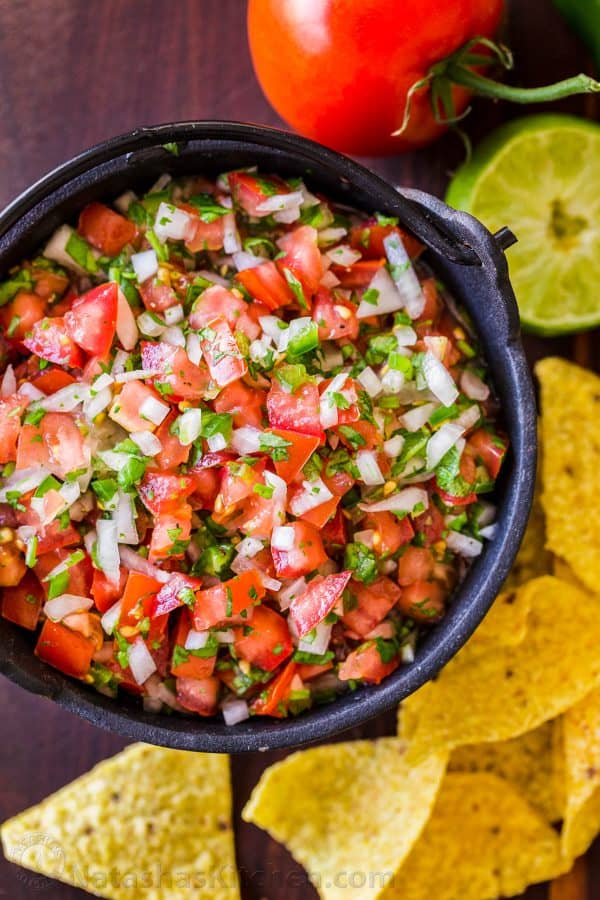 Mexican Pico De Gallo served as salsa fresca in a bowl surrounded by chips