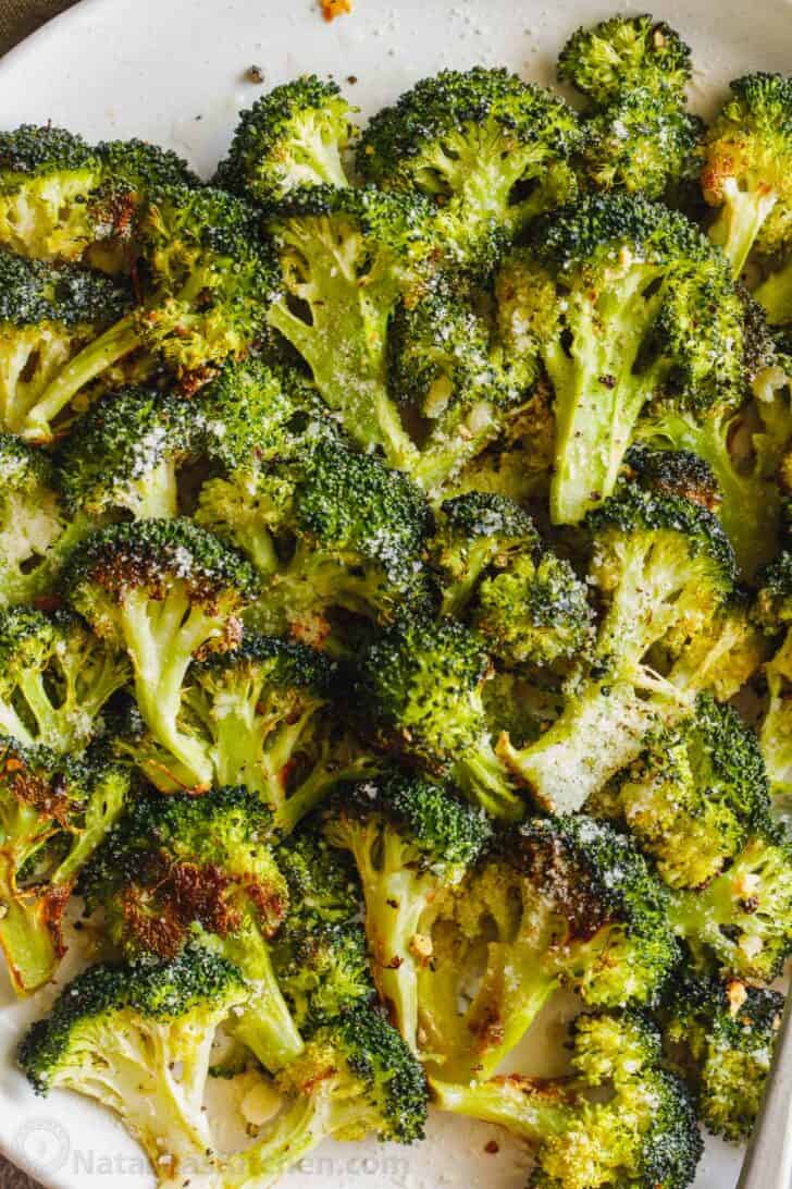 Broccoli on a plate with parmesan cheese.