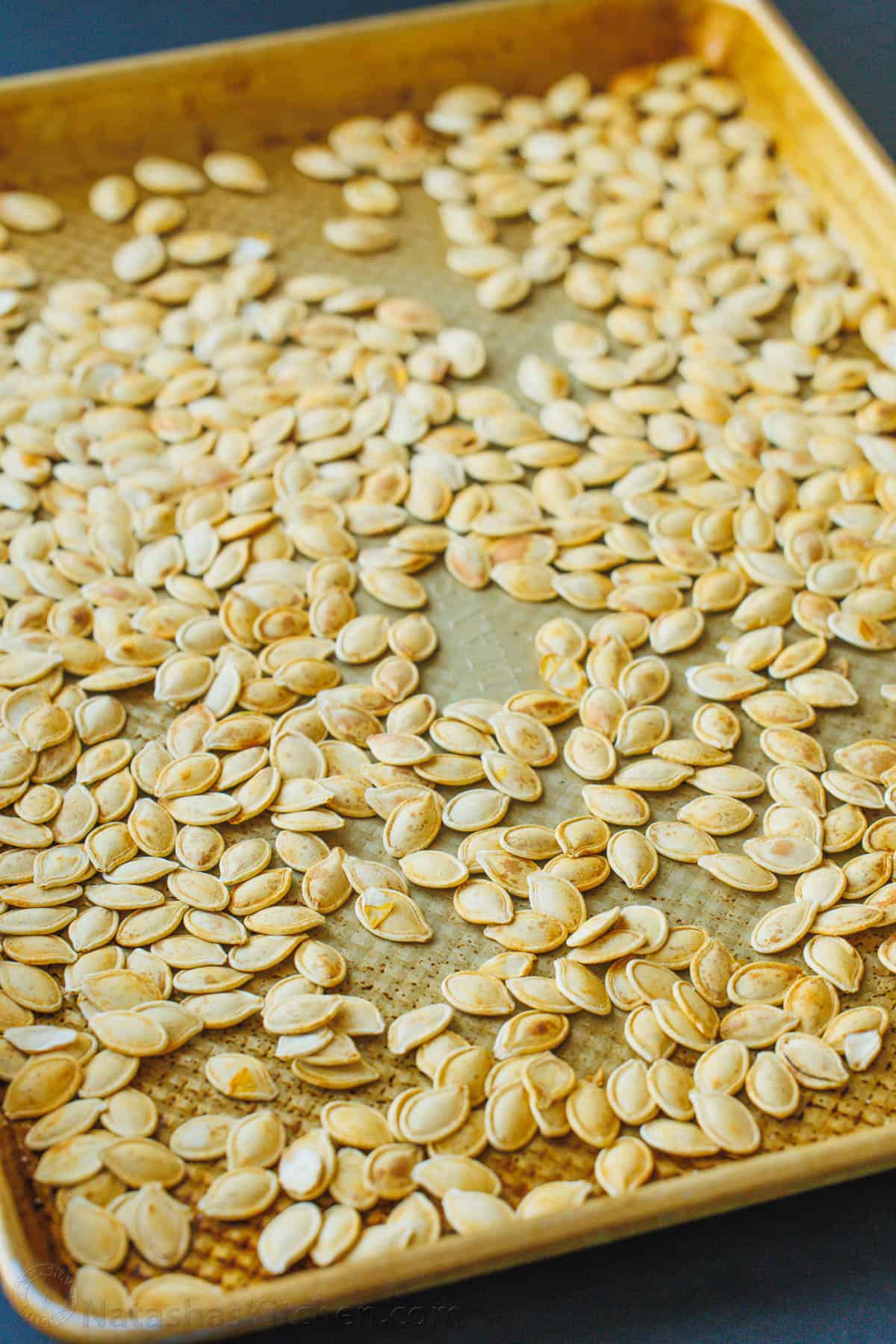 Roasted pumpkin seeds on a baking sheet