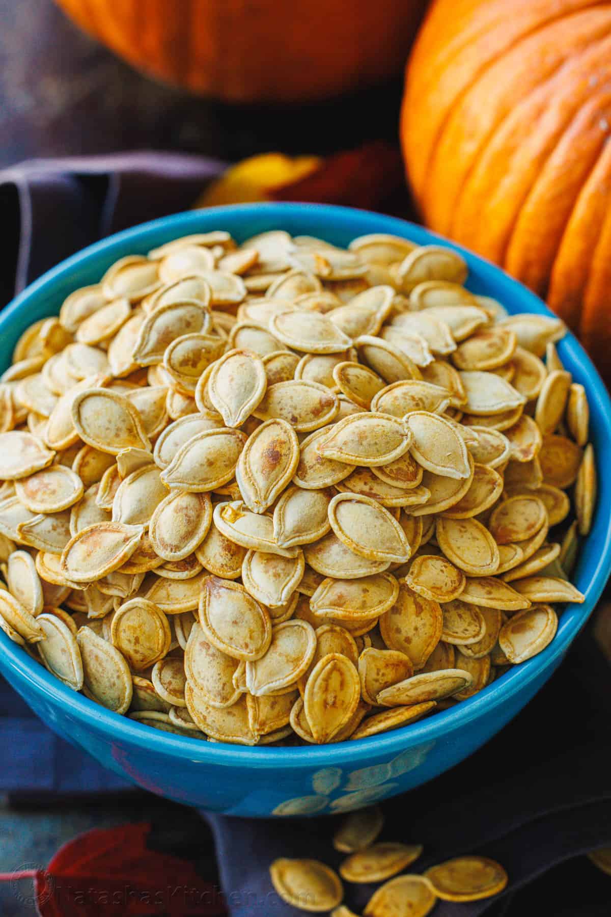 Roasted pumpkin seeds in a large blue bowl