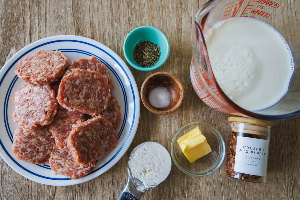 Ingredients for a Southern Breakfast staple including ground pork, salt, pepper, butter, flour, crushed red pepper and milk