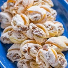 Meringue Shell Cookies have a crisp ribbon of meringue and soft crumbly center. These walnut meringue cookies are completely irresistible Christmas cookies! | natashaskitchen.com