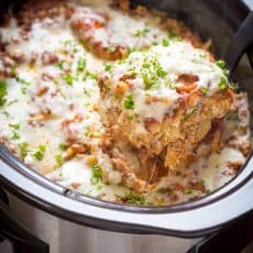 You'll make this slow cooker lasagna again and again! So saucy and cheesy! An easy make-ahead crockpot lasagna - the noodles cook right in the crockpot! | natashaskitchen.com