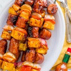 Grilled pineapple sausage skewers that are sweet, spicy, smoky and so flavorful! You won’t believe the easy glaze. Easy, excellent brunch skewers recipe. | natashaskitchen.com