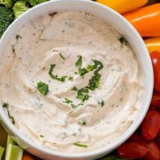 Veggie dip surrounded by fresh vegetables