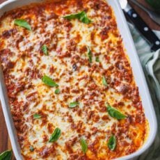 zucchini lasagna served in a white dish with basil leaves